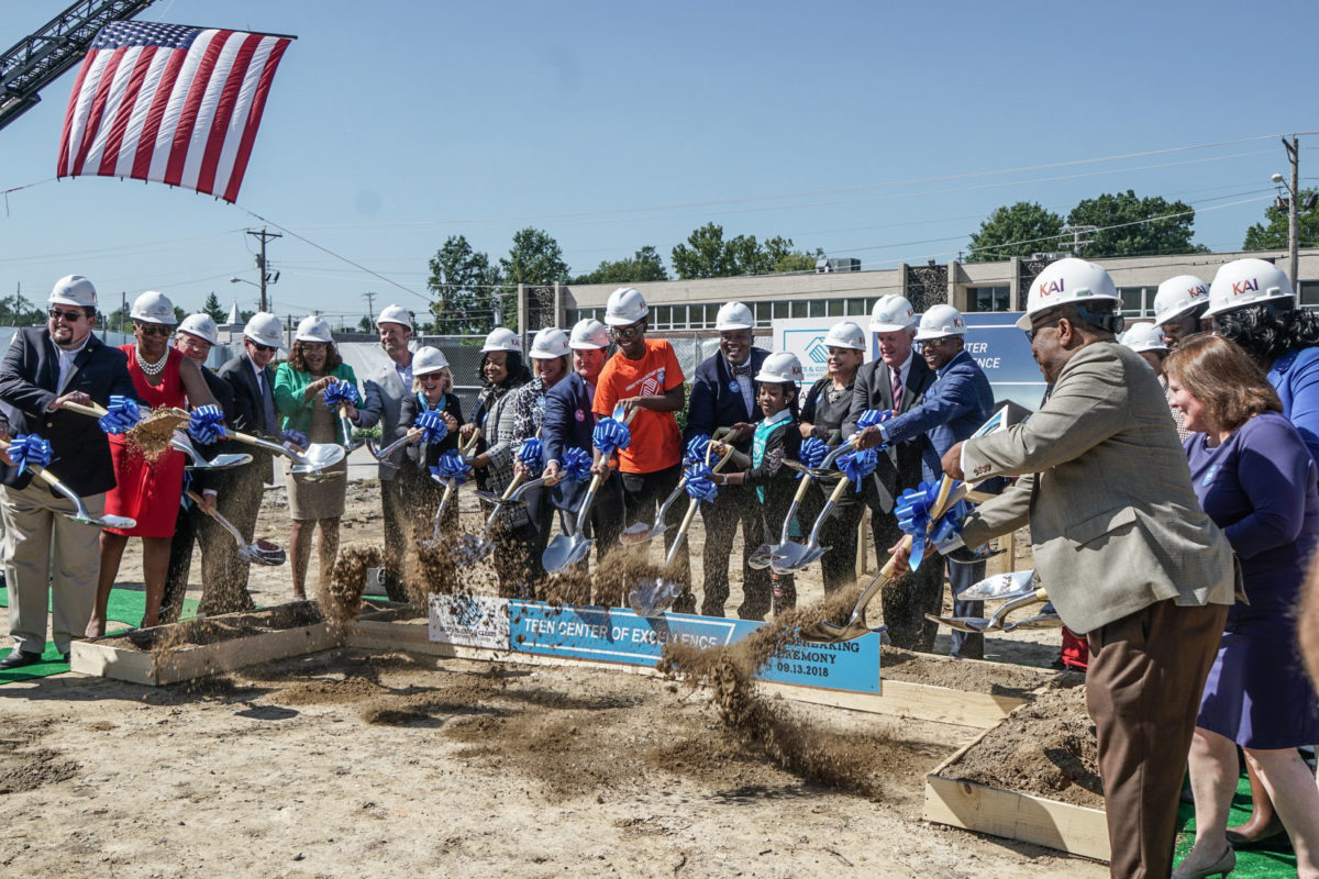 Attendees of the Boys & Girls Clubs ceremony shoveling dirt together