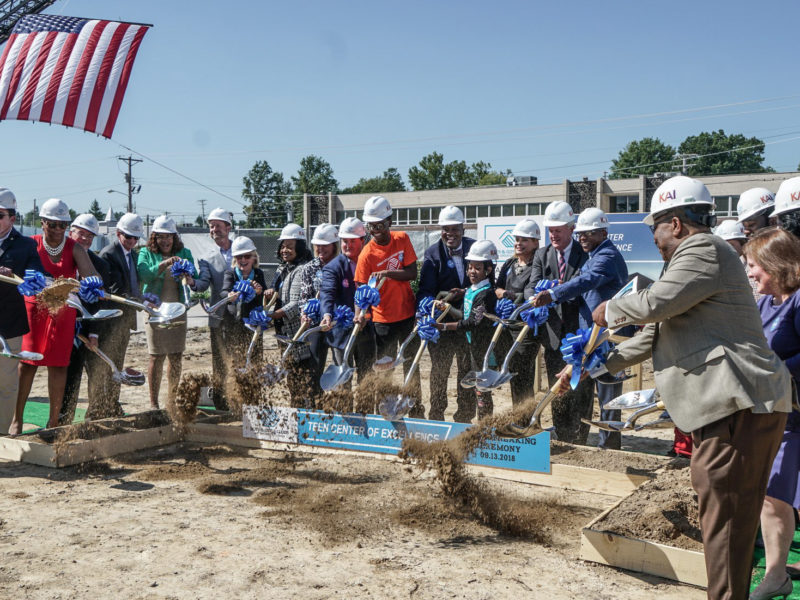 Attendees of the Boys & Girls Clubs ceremony shoveling dirt together