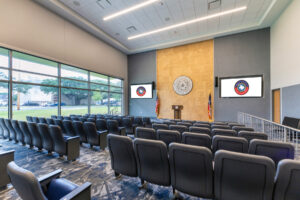 Room of chairs pointing at a podium for media debriefing.